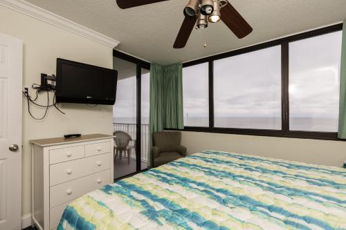 a bedroom with a bed and a flat screen tv at Sands Beach Club in Myrtle Beach