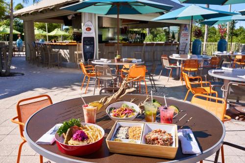 a table with bowls of food and drinks on it at Naples Grande Beach Resort in Naples