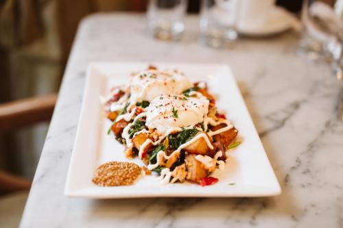 a white plate of food on a table at Hotel DeLuxe in Portland