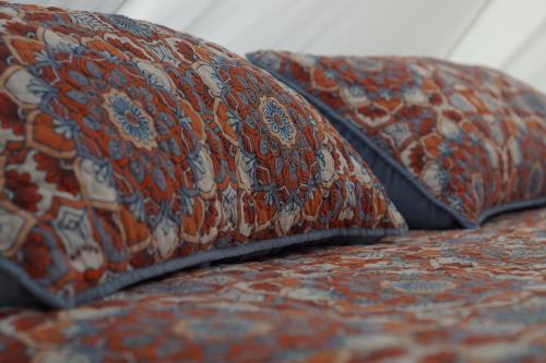 two pillows sitting on top of a bed at ChiloChill Glamping Resort in La Ventana