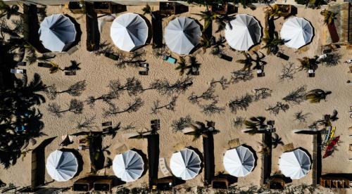 an overhead view of a building with white umbrellas at ChiloChill Glamping Resort in La Ventana