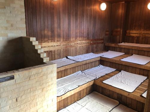 a room with four beds in a room with wood at Dormy Inn PREMIUM Kushiro in Kushiro