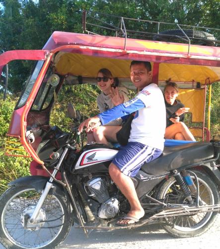 a man and a woman sitting on a motorcycle at Astillo's Guest Houses in Moalboal