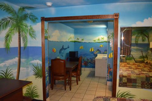 a dining room with a fish mural on the wall at Economy Inn New Orleans in New Orleans