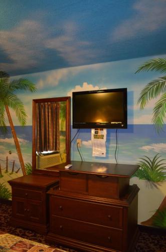 a room with a tv on top of a dresser at Economy Inn New Orleans in New Orleans