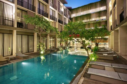 a swimming pool in the middle of a building at Hotel Terrace at Kuta in Legian