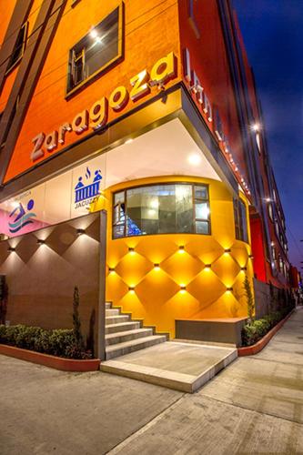 a building with a yellow door and stairs on it at HOTEL ZARAGOZA INN BOUTIQUE in Mexico City