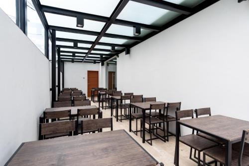 a row of tables and chairs in a room at RedDoorz Premium near Centre Point Mall Medan in Medan