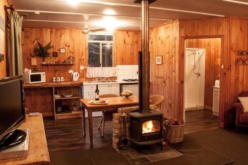 a kitchen with a stove in the middle of a room at Balingup Heights Hilltop Forest Cottages in Balingup