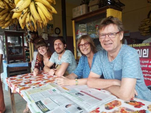 a group of people sitting at a table at Spice Garden Farm house in Sultan Bathery
