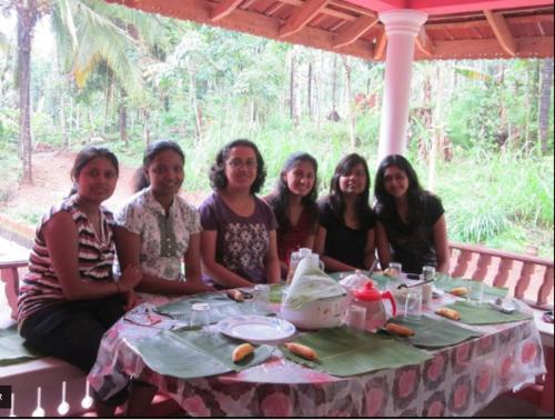 a group of people sitting at a table at Spice Garden Farm house in Sultan Bathery