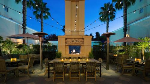 a restaurant with tables and a fireplace and palm trees at Hyatt Regency Valencia in Valencia
