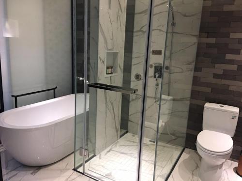 a bathroom with a shower and a toilet at Paco Hotel Dongpu Guanghzou -Free Shuttle Bus for Canton Fair in Guangzhou