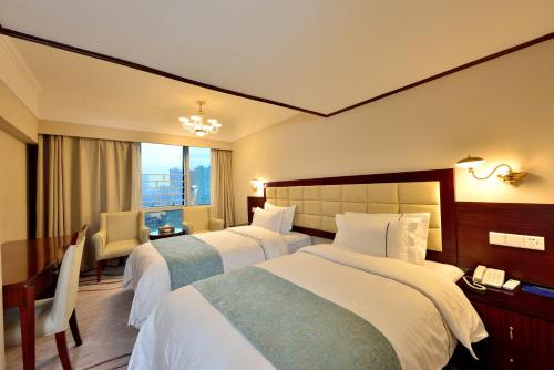 Postel nebo postele na pokoji v ubytování Hai Jun Hotel Guangzhou Beijing Road Tianzi Wharf Store