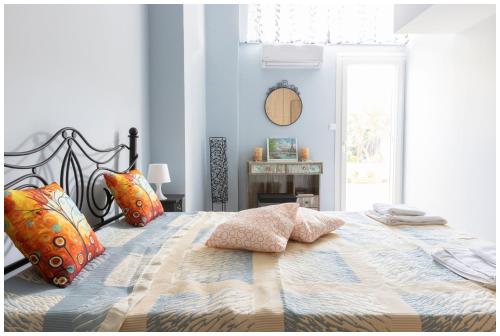 a bedroom with a large bed with pillows on it at SOTIRIA APARTMENT in Kiáton