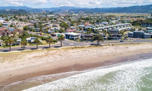 an aerial view of the beach and buildings at Waters Edge B&B in Whitianga