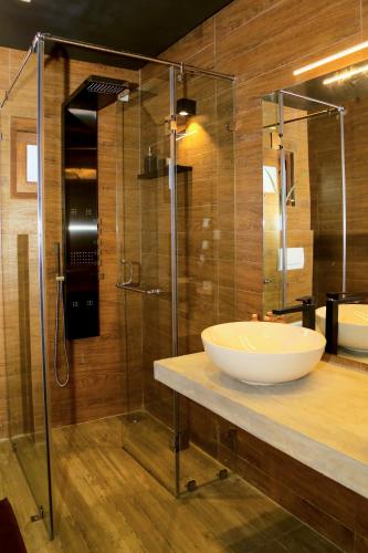 a bathroom with a sink and a glass shower at Eden Studio Apartments - 1 in Colombo