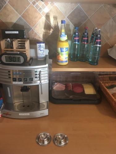 a kitchen counter with a toaster oven and bottles of soda at Gasthof Hotel Traube in Oberndorf
