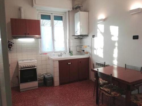 a kitchen with a table and a sink and a stove at Novegro Linate 101 in Linate