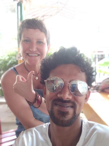 a man wearing sunglasses and a woman giving a thumbs up at Viraj's Garden in Tangalle