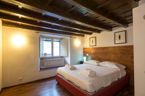 Schlafzimmer mit einem großen Bett mit einem Kopfteil aus Holz in der Unterkunft Calzaiuoli loft in Florenz