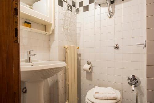 a small bathroom with a sink and a toilet at Calzaiuoli loft in Florence
