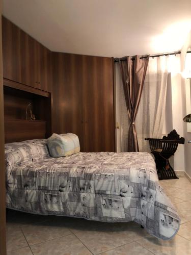 a bedroom with a bed with a blanket on it at La Residenza dei Papi in Papigno