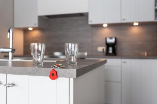 two glasses on a counter in a kitchen at Vakantiewoning Ter Luyghem in Houthulst
