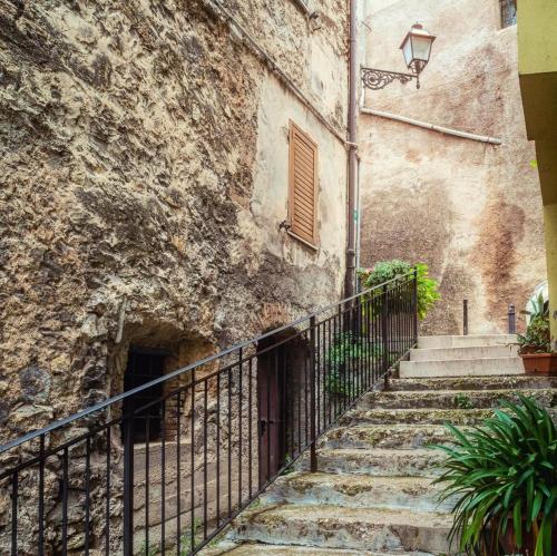 an old stone building with stairs and a gate at La Residenza dei Papi in Papigno