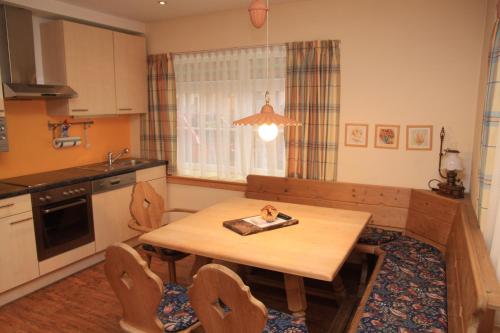 a kitchen with a wooden table with a plate on it at Appartements Reiterhaus in Wagrain