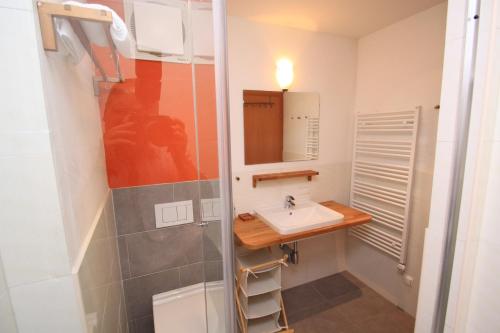 a bathroom with a sink and a shower at Appartements Reiterhaus in Wagrain