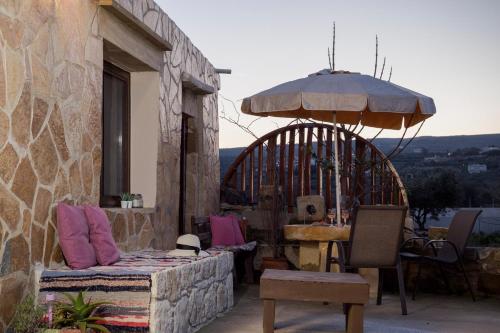a patio with a table and an umbrella at Μylos in Kissamos