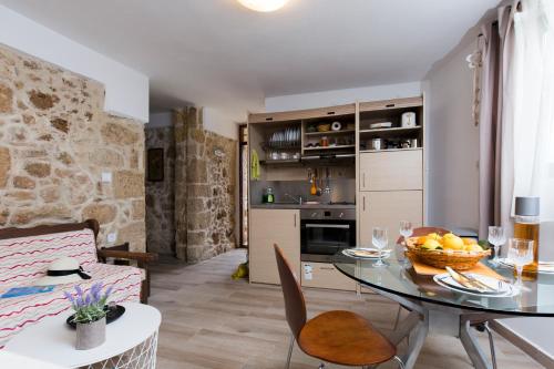 a kitchen and a dining room with a table and a room at Μylos in Kissamos