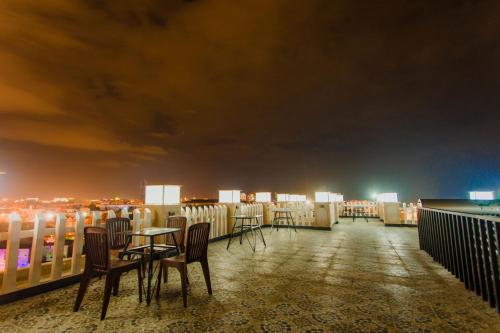 a rooftop patio with tables and chairs at night at Khách sạn Hoàng My in Tuy Hoa