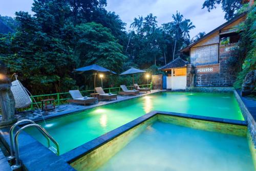 a pool at a resort in ubud at Ani's Villas in Ubud
