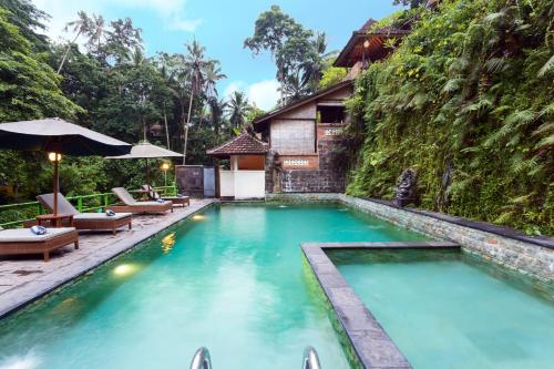 a pool at a resort in ubud at Ani's Villas in Ubud
