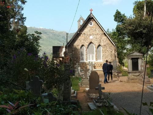 a man walking in front of a church at Homeaway Homestay Hatton in Hatton