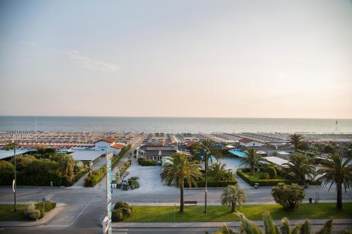 a view of a city with the ocean in the background at Grand Hotel in Forte dei Marmi