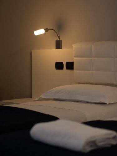 a bedroom with a bed with a lamp on it at Master Hotel Reggio Emilia in Reggio Emilia