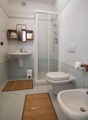 a bathroom with a shower and a toilet and a sink at Agrialpi by Salfrutta in Bricherasio