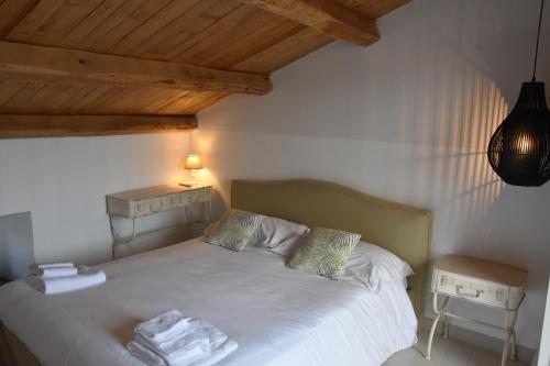 a bedroom with a bed with towels on it at La Casa nel Borgo Antico in Melfi