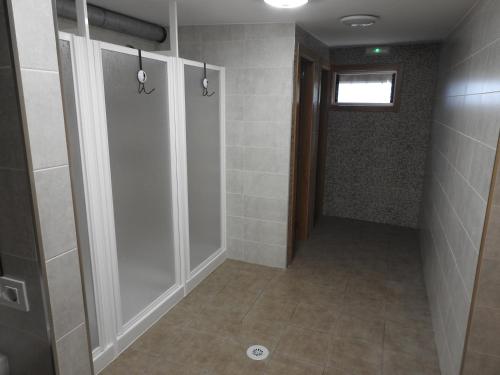 a bathroom with a shower stall and a walk in shower at Albergue Buen Camino Tui in Tui
