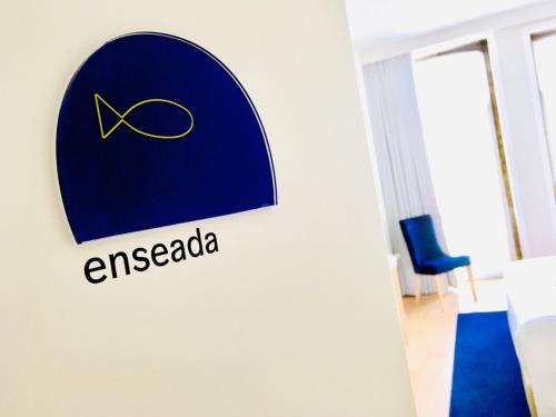 a sign for an agenda logo in a hotel room at ó Poboa Guesthouse in Póvoa de Varzim