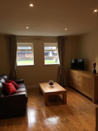 a living room with a couch and a coffee table at Shannon Oaks Apartments in Portumna