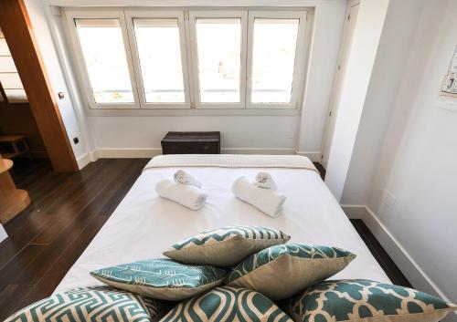 a bedroom with a bed with two pillows on it at Malagueta Beach in Málaga