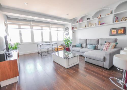 a living room with a couch and a table at Malagueta Beach in Málaga