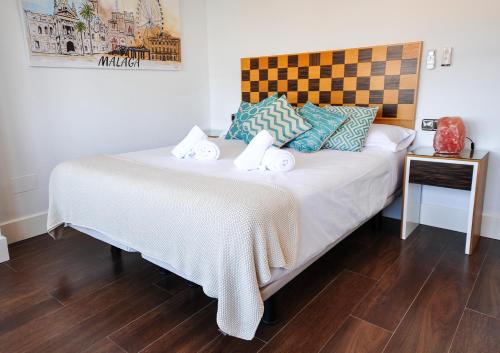 a bedroom with a large bed with towels on it at Malagueta Beach in Málaga
