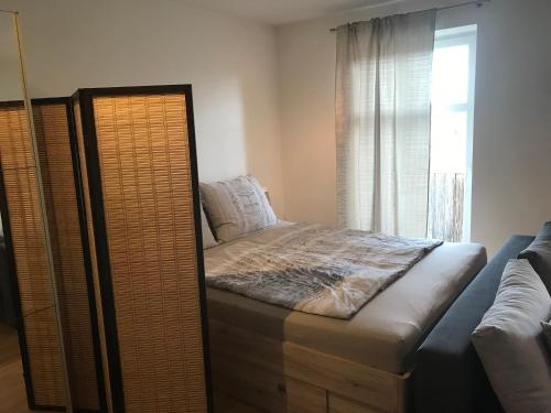 a bedroom with a bed and a window at Apartment Na skali in Kranj