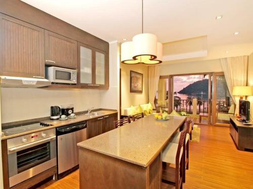 a kitchen with a large island in the middle of a room at Point of view condos, tranquility bay, koh chang in Ko Chang