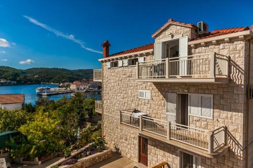 a building with balconies and a view of the water at Apartments Sumartin in Sumartin